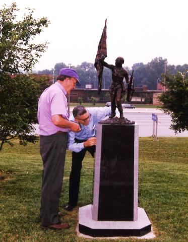 Sculptor Don Rubin (right) and Memorialist Doug Logan, putting the finishing touches on the One Army Statue at Veterans Memorial Park prior to its dedication in 1998.